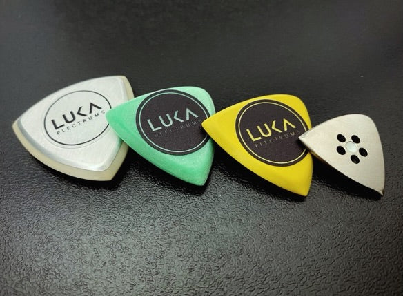 custom order guitar plectrums in shape of triangle and hybrid made of torlon, uhmwpe, peek, aluminium and titanium